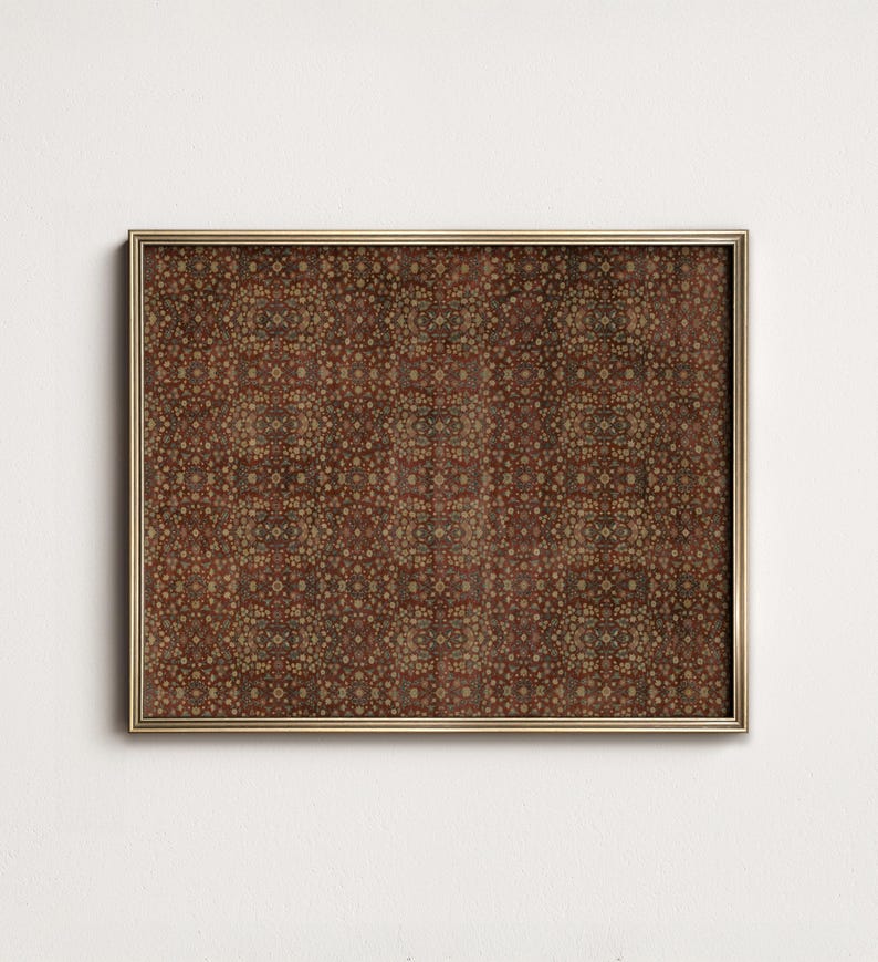 May include: A framed print with a detailed, repeating pattern in shades of brown, red, and gold. The pattern features small, circular shapes and intricate designs, creating a textured appearance. The frame is a thin, gold colour, adding a touch of elegance.