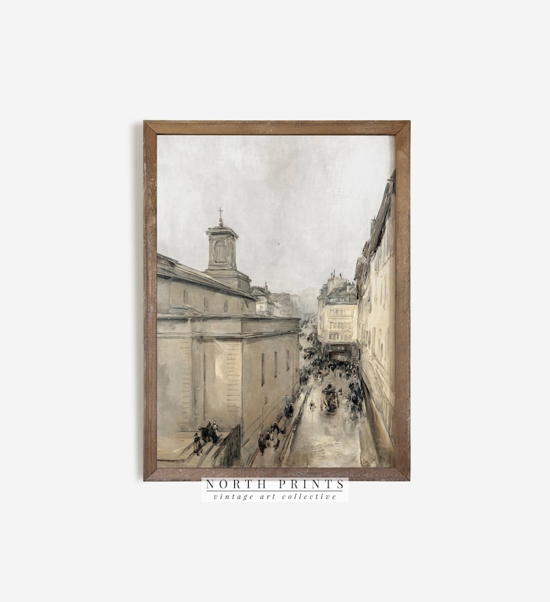 May include: A vintage watercolour painting depicting a street scene in a European city. The painting features a tall building with a steeple, a cobbled street, and people walking along the street. The painting is framed in a wooden frame.