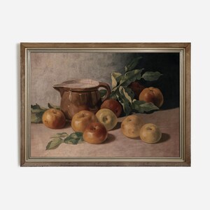 May include: A still life painting of a brown ceramic pitcher and apples in a wooden frame. The pitcher is filled with a white liquid and is surrounded by apples of various shades of red, yellow, and green.