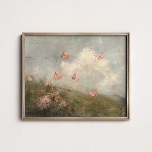 May include: A framed painting featuring a serene landscape with pink butterflies fluttering against a cloudy sky. The artwork has a vintage aesthetic, with soft colors and a gold frame. The scene includes a grassy hill and pink flowers.