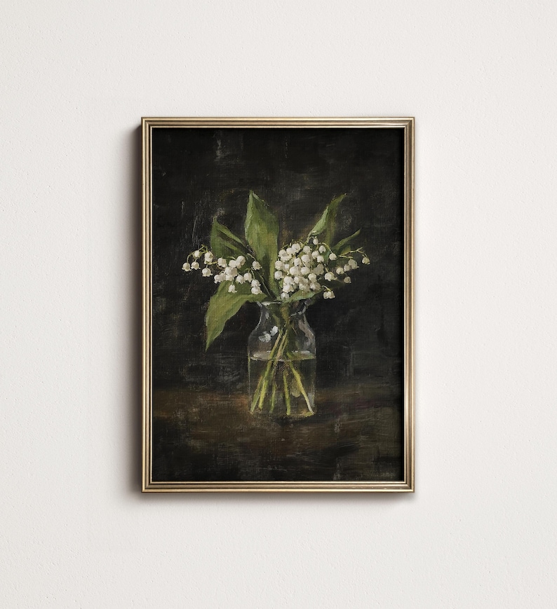 May include: A framed painting of a bouquet of white lily of the valley flowers in a clear glass vase against a dark background.