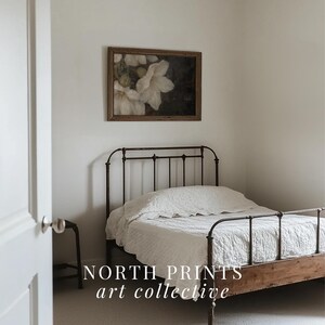 May include: A white iron bed frame with a white linen duvet and a framed floral print above the headboard. The text "NORTH PRINTS art collective" is visible in the bottom of the image.
