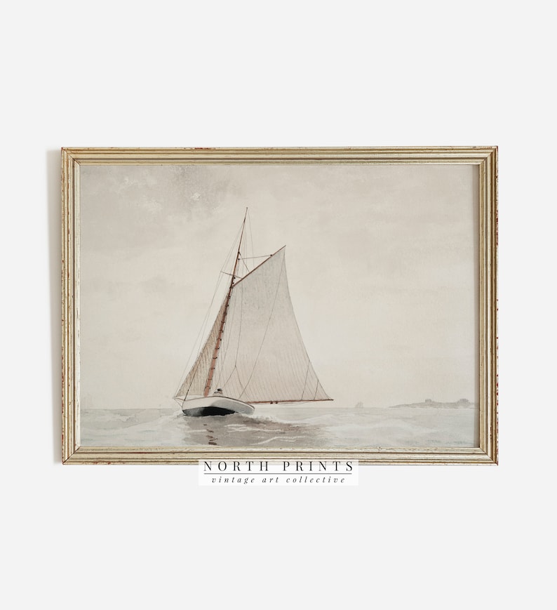 May include: A vintage watercolor painting of a sailboat on the water. The sailboat has a white sail and a brown hull. The water is a light blue color and the sky is a light gray color. The painting is framed in a light wood frame. The text "NORTH PRINTS vintage art collective" is at the bottom of the painting.