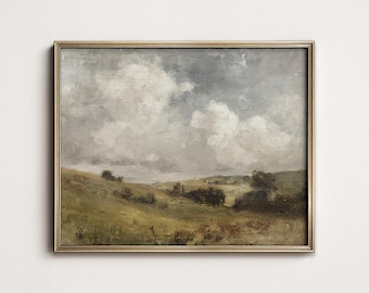 May include: A framed landscape painting with a gold-colored frame. The artwork depicts a rolling green hillside under a cloudy sky. The painting has a vintage, antique aesthetic, with soft brushstrokes and muted colors.