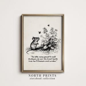 May include: A framed print with a black and white illustration of a mouse, flowers, and bees. The text reads, "The little mouse paused to smell the flowers, for even the tiniest hearts know how to treasure small wonders." The print is from the "storybook collection."