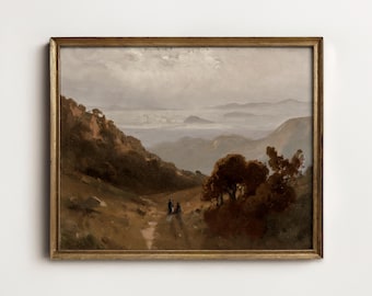 May include: A landscape oil painting in a thin gold frame depicting a hazy mountain valley with dark brown trees in the foreground, a winding path, two small figures, and distant blue-toned hills under a cloudy, overcast sky.