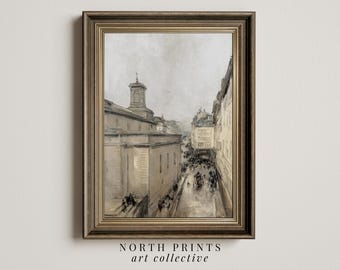 May include: A framed painting of a city street scene with a church in the background. The painting is in a muted color palette of grays and browns. The street is lined with buildings and there are people walking on the street.