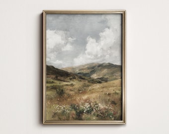 May include: A framed landscape painting with a gold-colored frame. The artwork depicts a valley with rolling hills, a cloudy sky, and wildflowers in the foreground. The color palette includes greens, browns, and blues, creating a serene atmosphere.