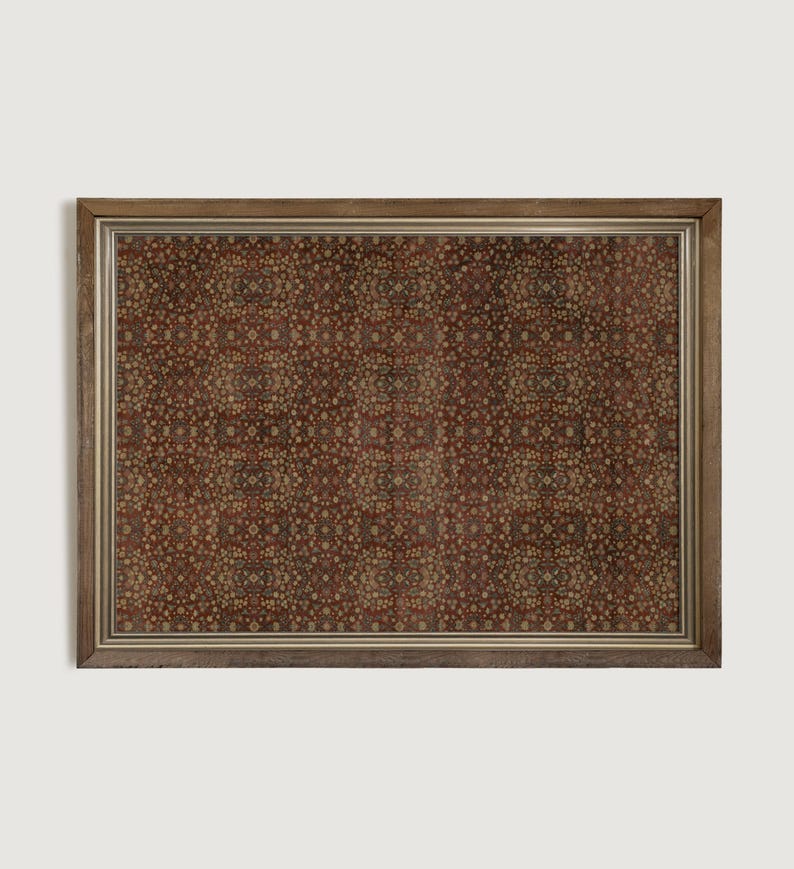 May include: A framed print with a detailed, repeating pattern in shades of brown, beige, and red. The symmetrical design features small, circular elements. The frame is a warm, light brown colour, enhancing the vintage aesthetic.