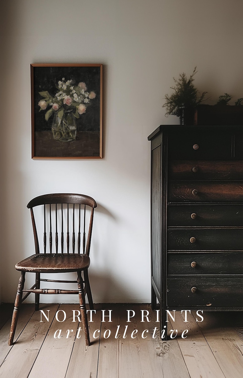 May include: A vintage wooden chair with a dark brown finish sits in front of a dark wood dresser with six drawers. A framed painting of a vase of flowers hangs on the wall behind the chair. The text "NORTH PRINTS art collective" is printed on the floor in front of the chair.