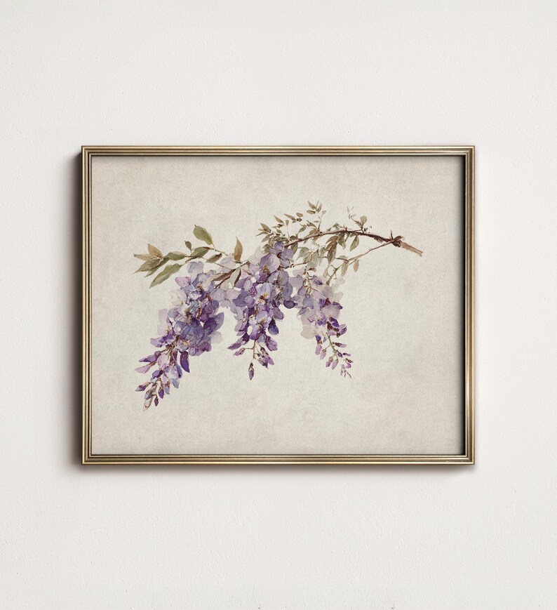 May include: A framed print featuring a watercolor illustration of wisteria blossoms. The artwork showcases cascading purple flowers and green leaves against a neutral background, enclosed in a gold-colored frame.