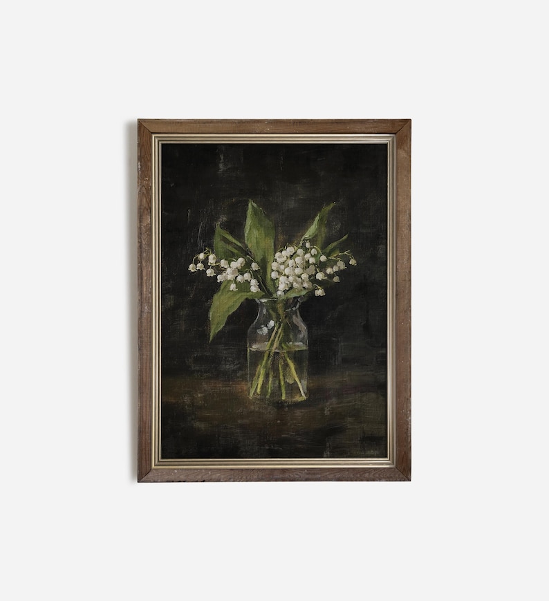 May include: A framed painting of a bouquet of white lilies in a clear glass vase. The lilies are arranged in a simple, elegant way, and the painting is done in a realistic style. The background is a dark, muted color, which helps to highlight the lilies.