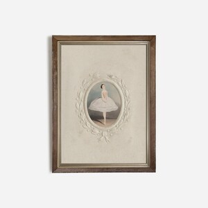 May include: A framed print of a ballerina in a white tutu, standing on one leg with her arms crossed. The print is surrounded by a white, decorative frame with a floral design.