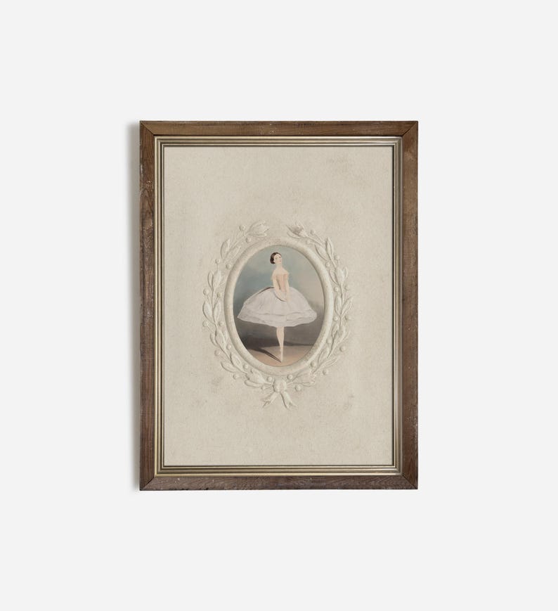May include: A framed print of a ballerina in a white tutu, standing on one leg with her arms crossed. The print is surrounded by a white, decorative frame with a floral design.