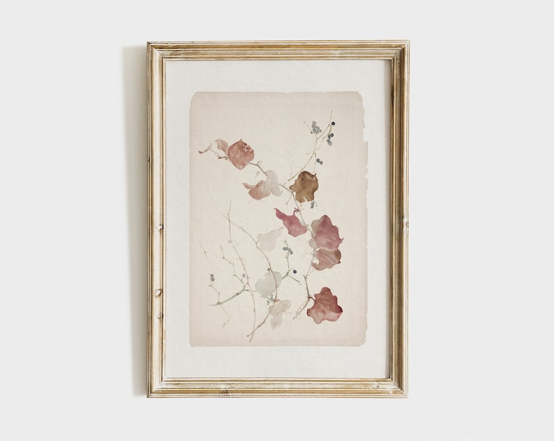 May include: A framed watercolor painting of a delicate branch with brown and pink leaves and small black berries. The painting is on a light beige background and is framed in a light wood frame.
