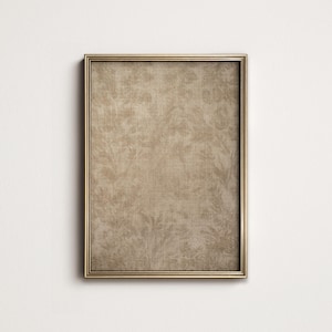 May include: A gold-toned picture frame with a textured, beige canvas insert. The frame has a simple, classic design.