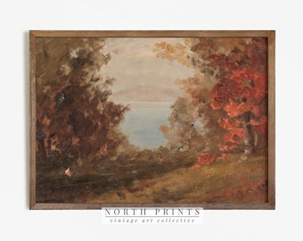 May include: A vintage painting depicting a lake scene with trees and foliage in shades of brown, red, and green. The lake is a light blue colour and the sky is a pale grey. The painting is framed in a brown wood frame. The text "NORTH PRINTS vintage art collective" is at the bottom of the painting.
