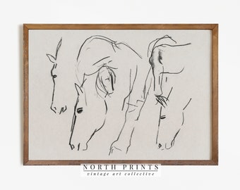 May include: A black and white line drawing of three horses in a minimalist style. The drawing is framed in a light brown wood frame. The bottom of the frame has the text "NORTH PRINTS vintage art collective".