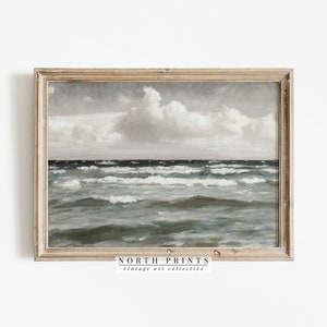 May include: A framed painting of a seascape with a cloudy sky and choppy waves. The painting is in a light wood frame with a white mat. The text "NORTH PRINTS vintage art collective" is at the bottom of the frame.