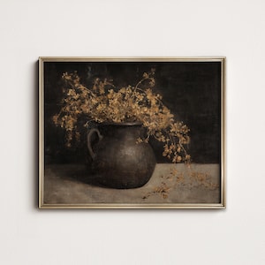 May include: A framed still life painting featuring a dark brown, handled vase filled with dried, golden-brown flowers. The vase sits on a light gray surface against a dark background. The painting is in a gold frame.