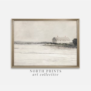 Puede incluir: Una pintura de acuarela enmarcada de una casa blanca con techos rojos en una pequeña isla. La casa está rodeada de agua y un cielo azul claro. La pintura está en un marco dorado. El texto "NORTH PRINTS art collective" está debajo del marco.