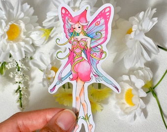 May include: A pink and blue fairy sticker with wings and a flower-shaped dress. The fairy has long blonde hair and blue eyes.