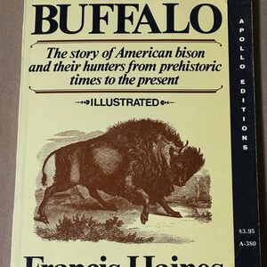 May include: A vintage book titled "The Buffalo" by Francis Haines. The cover features a brown illustration of a bison and text describing the story of American bison and their hunters. The book is part of the Apollo Editions series.