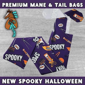 May include: Purple fabric mane and tail bag with a Halloween theme. The bag is printed with orange and white ghosts, rakes, and the words "Boo!" and "Spooky".