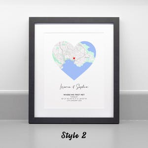 May include: A framed print featuring a heart-shaped map of Torquay with a red heart icon marking a specific location. Below the map, the text reads Lauren & Sophia, WHERE WE FIRST MET, TORQUAY, 50 27' 44.146 N, 3 31' 38.923 W, 12TH JANUARY 2024.