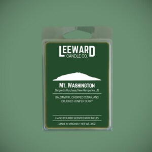 May include: A green wax melt package from Leeward Candle Co. features the text "MT. WASHINGTON" and ingredient details. The package includes a clear plastic casing and a hanging hole. The net weight is 3 oz.