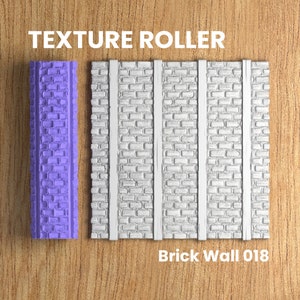 May include: A purple texture roller with a brick wall pattern. The roller is used to create a brick wall texture on surfaces. The image also shows a sample of the texture created by the roller. The text "Brick Wall 018" is below the sample.