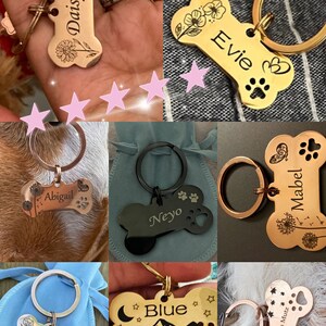 May include: A collection of personalized dog tags in a bone shape. The tags are made of metal and feature engraved names, paw prints, and decorative elements like flowers, mountains, and stars. Each tag is attached to a keyring.