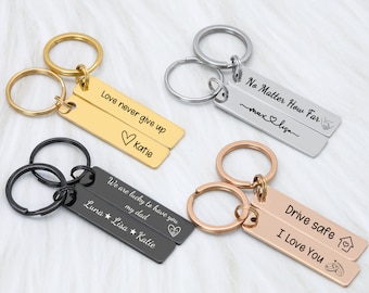 May include: Four sets of double-sided keychains with engraved messages. The keychains are in gold, silver, black, and rose gold. The messages include "Love never give up Katie", "No Matter How Far max&lisa", "We are lucky to have you my dad Luna Lisa Katie", and "Drive safe I Love You".