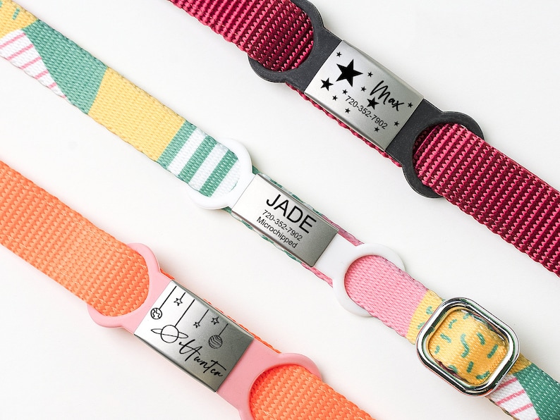 K&ouml;nnte beinhalten: Drei bunte Hundehalsb&auml;nder mit personalisierten Metalletiketten. Die Halsb&auml;nder sind rot, rosa und orange mit verschiedenen Mustern. Die Etiketten sind mit den Namen "Max", "Jade" und "Hunter" sowie Telefonnummern graviert.