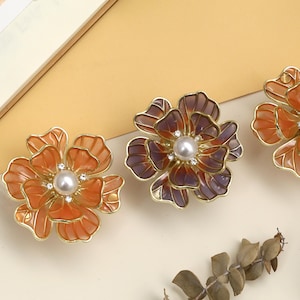 May include: A set of three ceramic mugs with a speckled, matte finish. The mugs are in shades of cream, light gray, and dark gray. Each mug has a simple, minimalist design, perfect for coffee or tea.