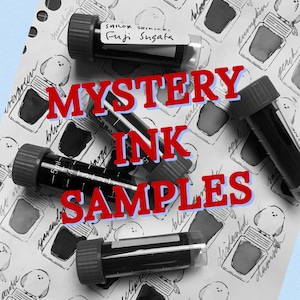 May include: A collection of mystery ink samples in clear vials with black caps, labeled with the text "Mystery Ink Samples." The vials are arranged on a patterned paper with ink bottle illustrations and handwritten labels.