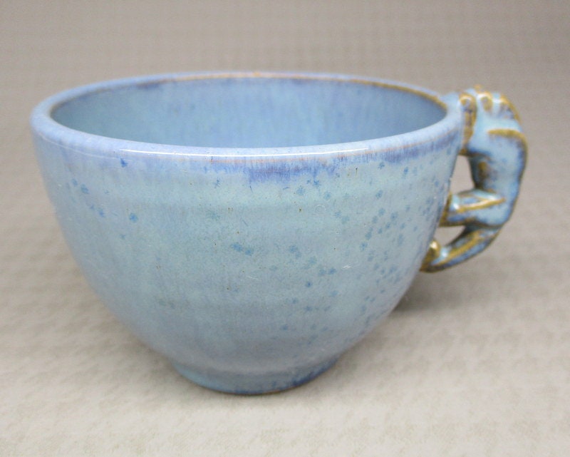Shearwater pottery cup with monkey handle , no saucer (2356)