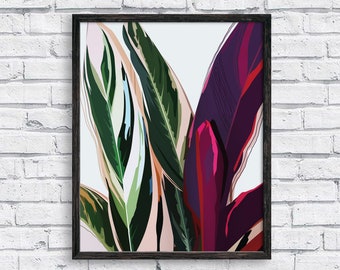 May include: A framed print featuring a stylized illustration of tropical leaves in shades of green, pink, and purple.