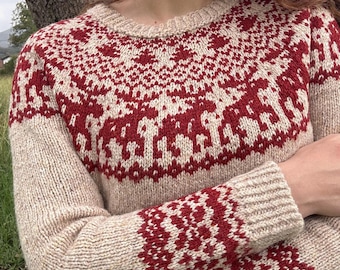 May include: A beige knitted sweater with a red pattern of reindeer and geometric shapes. The sweater has a crew neck and long sleeves with matching red and beige cuffs. The design is repeated on the upper chest and sleeves.