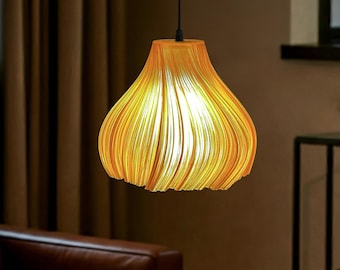 May include: A pendant light fixture featuring a bell-shaped shade with a ribbed, layered texture in a warm orange hue. The shade is suspended by a thin black cord and emits a soft, glowing light from within its structured, curved form.