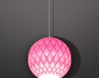 May include: A spherical pendant light fixture featuring a vibrant pink, geometric lattice pattern. The structure is composed of interlocking diamond-shaped segments that create a textured, faceted surface, suspended by a thin, light-colored cord.