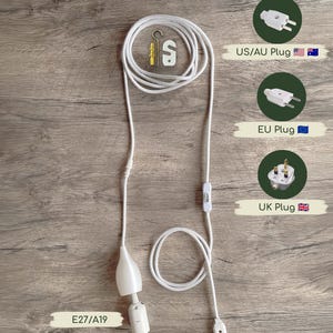 A white plug-in lamp cord with an E27/A19 socket, an inline switch, and mounting hooks. The set includes a 4-meter (157.5 inches) cord and options for US/AU, EU, or UK plugs, designed for installation within a lampshade.