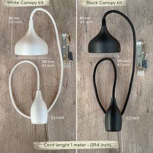 Two ceiling canopy kits, one white and one black, each featuring a 3.5 inch diameter canopy, a 4.1 inch tall socket, and a 39.4 inch cord. Each kit includes mounting hardware and is compatible with E27/A19 bulbs for lighting installations.