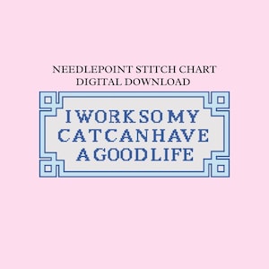 May include: A digital needlepoint stitch chart with the text "I WORK SO MY CAT CAN HAVE A GOOD LIFE" in a blue and white pixelated design. The text is inside a blue rectangular frame on a light pink background.
