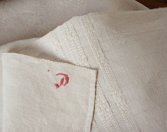 May include: Two white linen tablecloths, one with a red embroidered letter "D" in the corner.