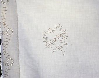 May include: White linen fabric with a delicate floral embroidery design. The embroidery features a heart shape with the word "Grizlike" stitched inside.