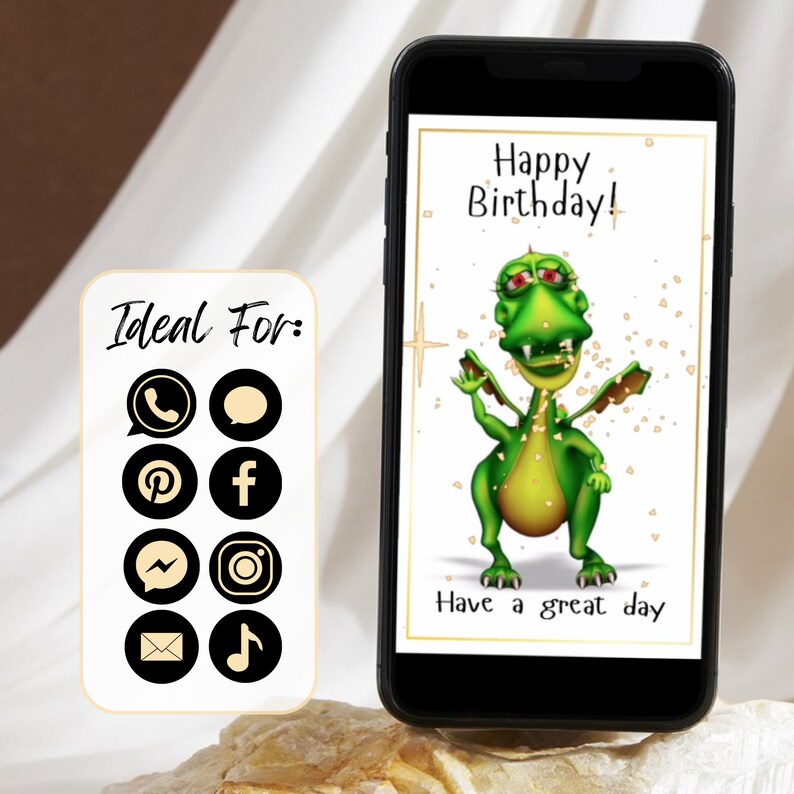 Birthday ecard. A green cartoon dragon with red eyes and a toothy grin on a white background. The dragon is standing on its hind legs with its wings spread out. The text 'Happy Birthday!' is above the dragon and the text 'Have a great day' is below the dragon. The image is on a smartphone screen with a black frame. The image is ideal for sharing on social media, text messaging, email.