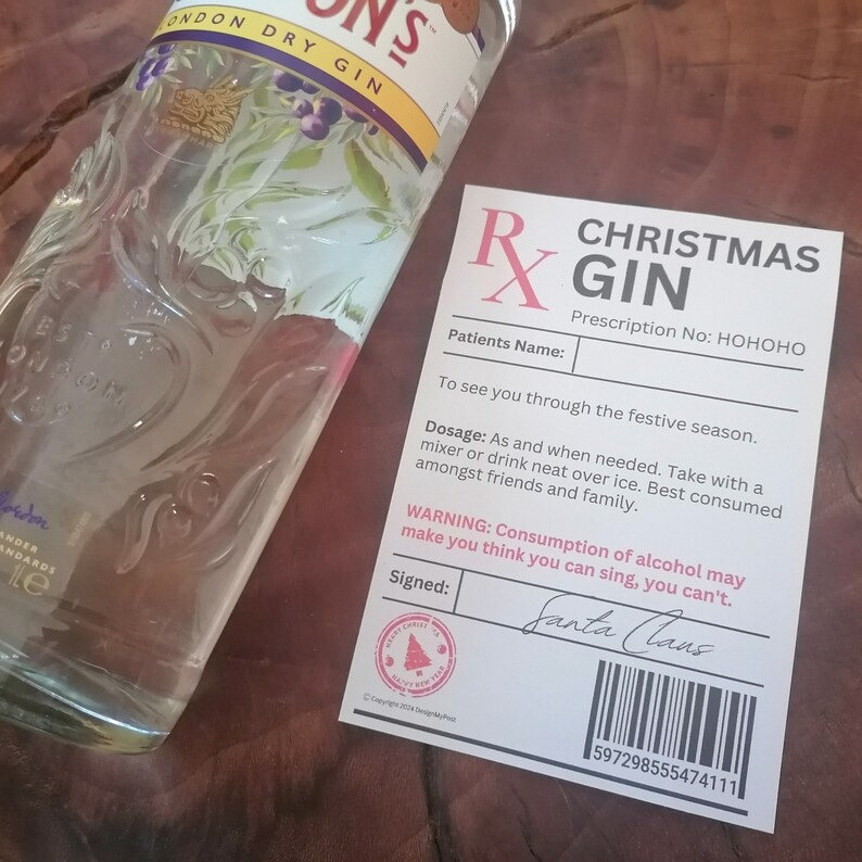May include: A white prescription label with red text that reads "Christmas Gin" and "Prescription No: HOHOHO". The label has a red cross symbol and a space for a patient's name. The label also includes instructions for dosage and a warning about the effects of alcohol. The label is signed "Santa Claus".