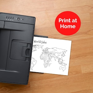 May include: A black printer sits next to a white sheet of paper featuring a black and white outline map of the world with the text World Sales. A red circular graphic with the white text Print at Home is positioned in the upper right corner.