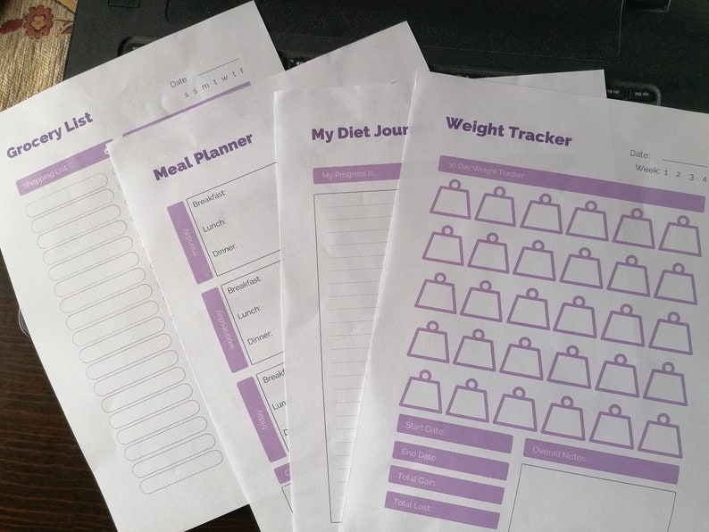 May include: A set of printable planner pages with a purple and white color scheme. The pages include a grocery list, meal planner, diet journal, and weight tracker. The weight tracker has a 30-day weight tracker section with 30 weight icons.
